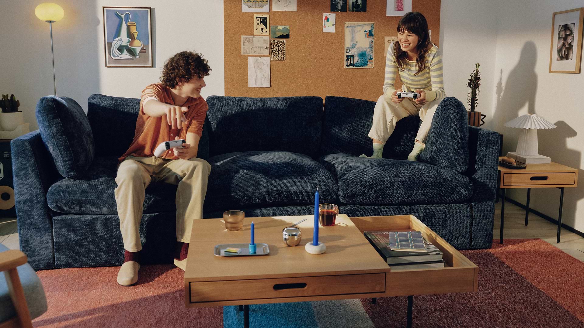 Couple laughing on blue sofa