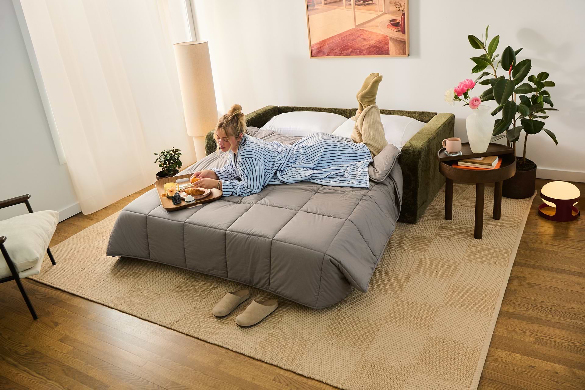 A person lounging on a sofa bed