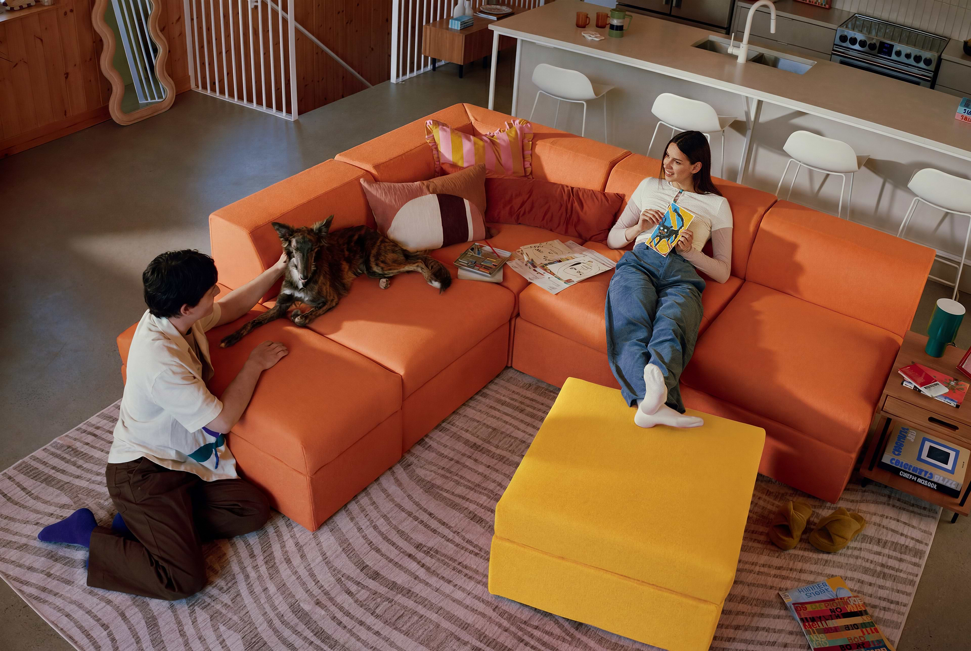 A couple and their dog sitting on a sofa