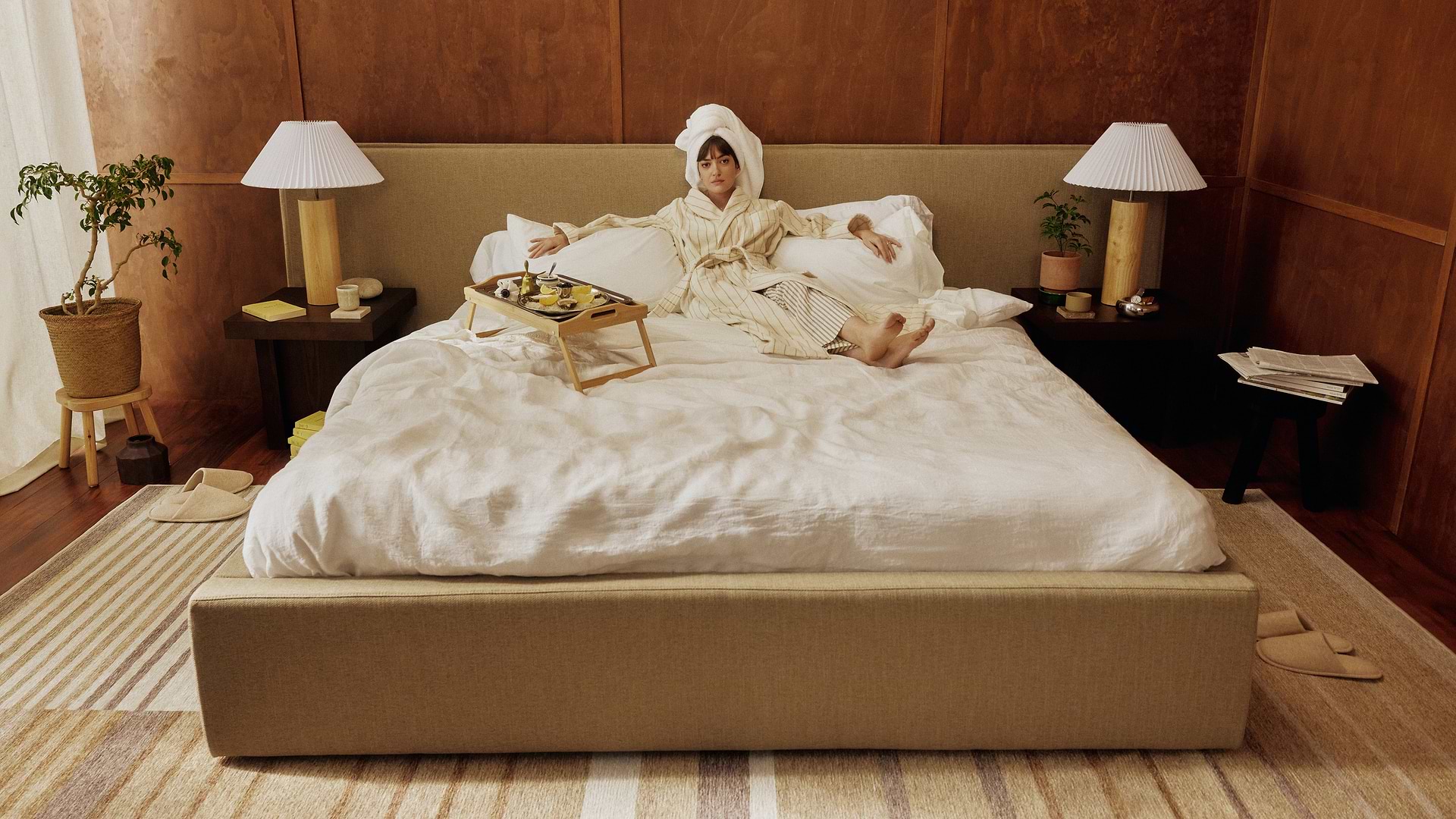 Woman lying on upholstered bed