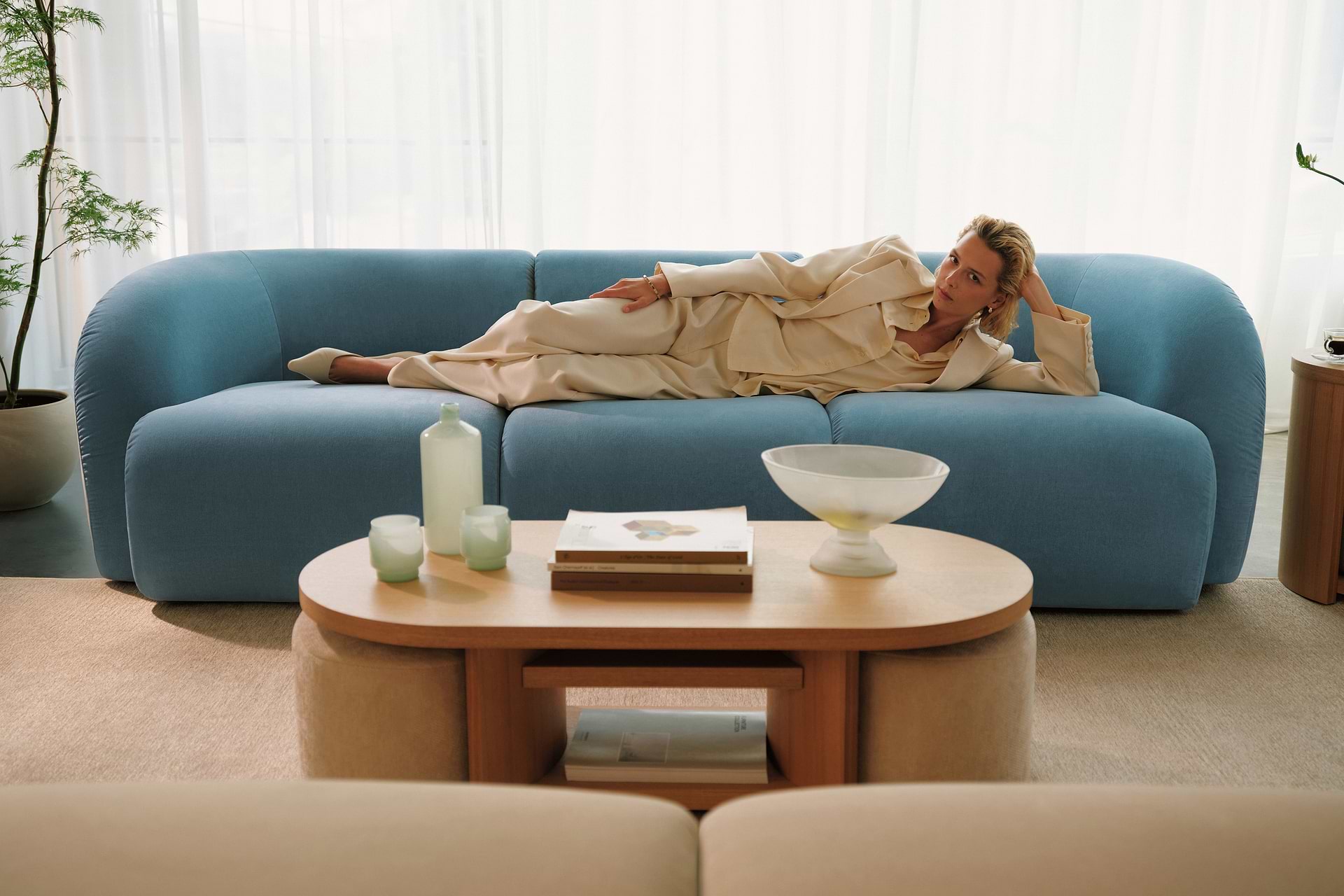 Woman lying on blue sofa
