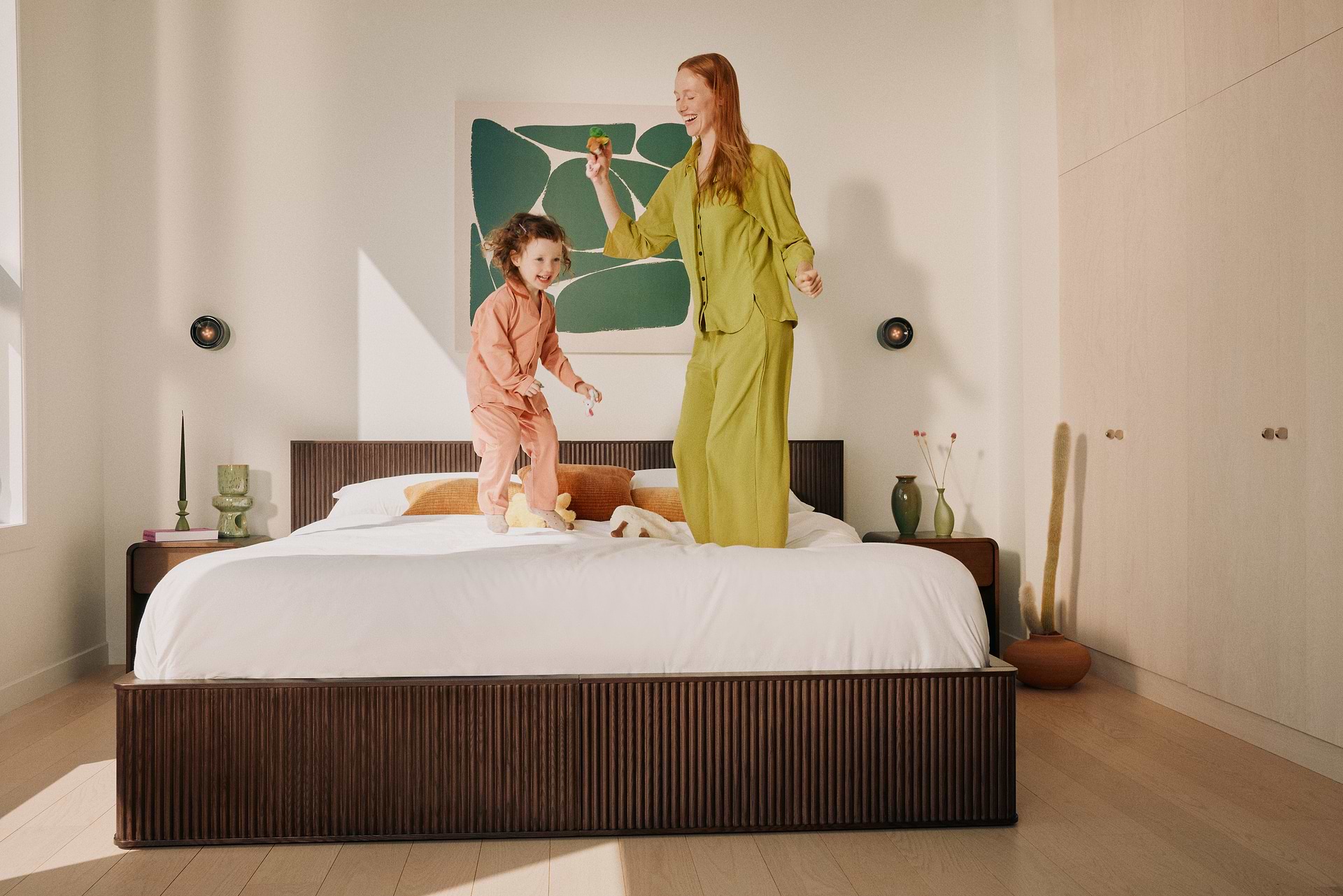 Mother and child dancing on bed