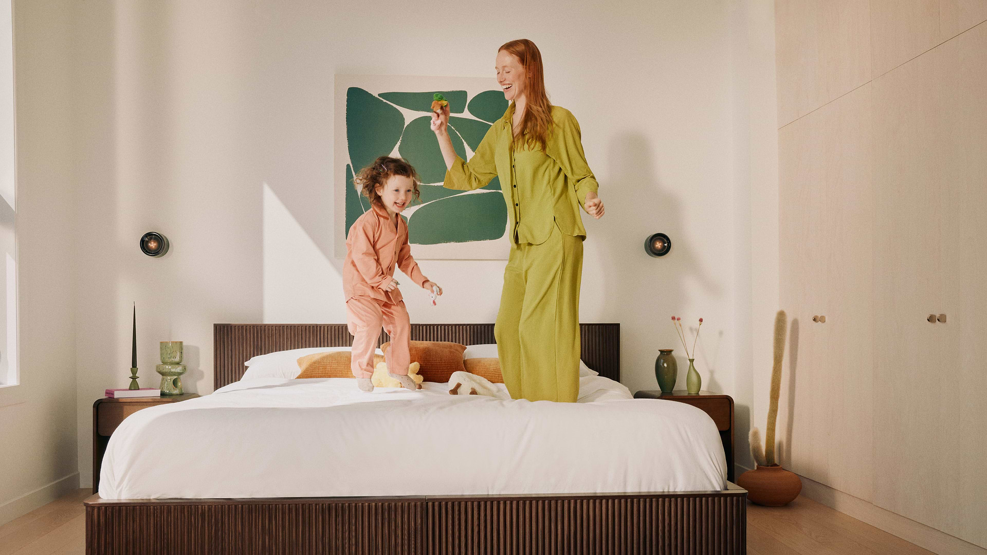 Mother and child dancing on bed