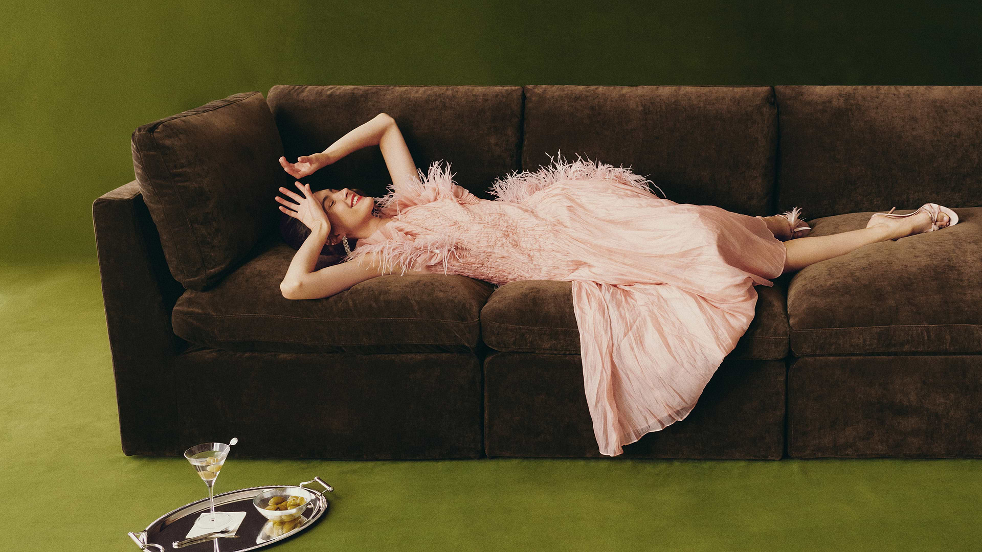 Woman flopped on a brown sofa