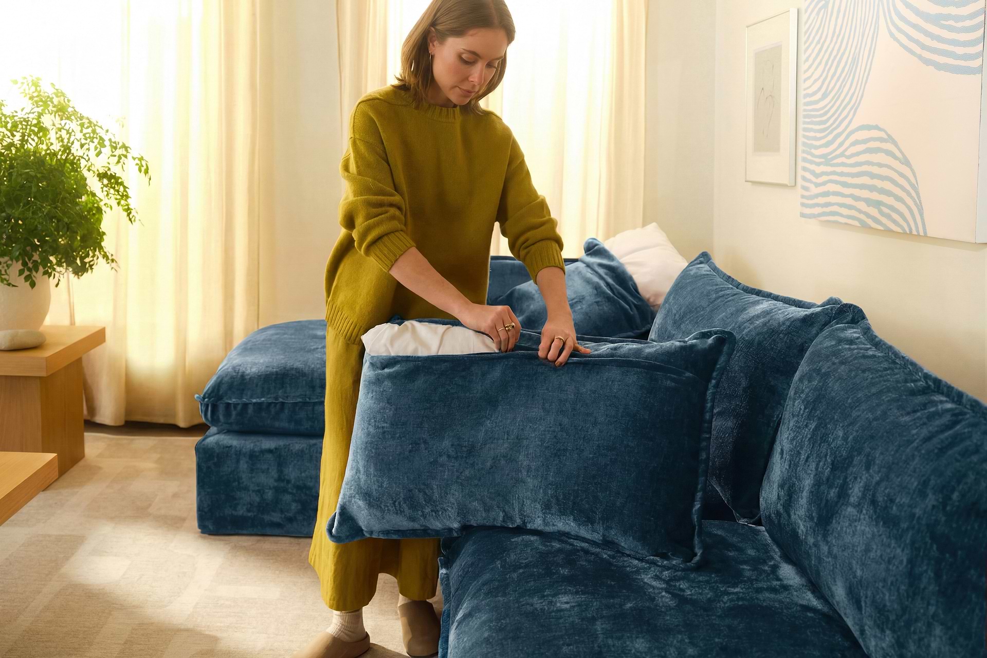 Person sliding removable base covers onto the sofa base.