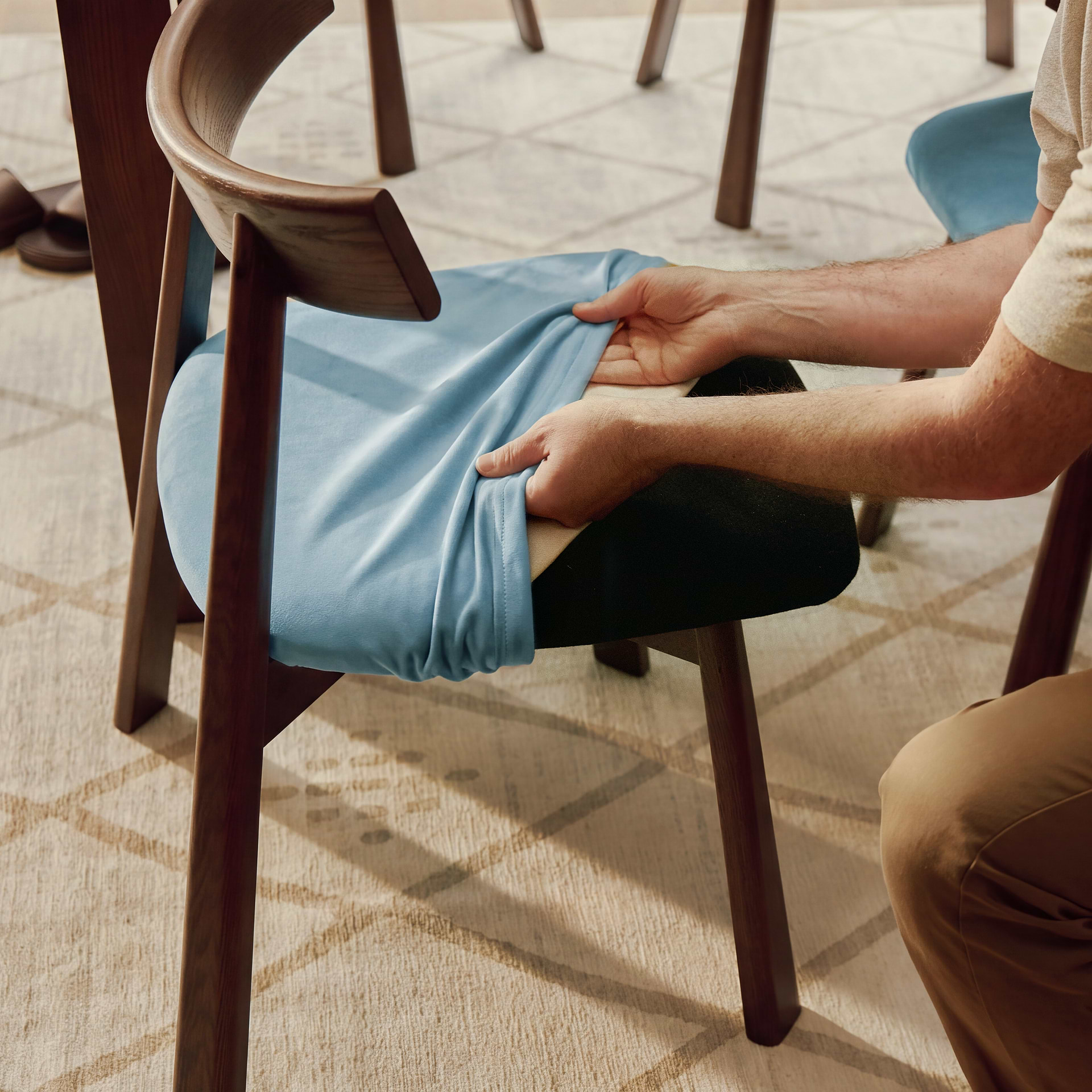 Men placing the yellow ushi chair cushion