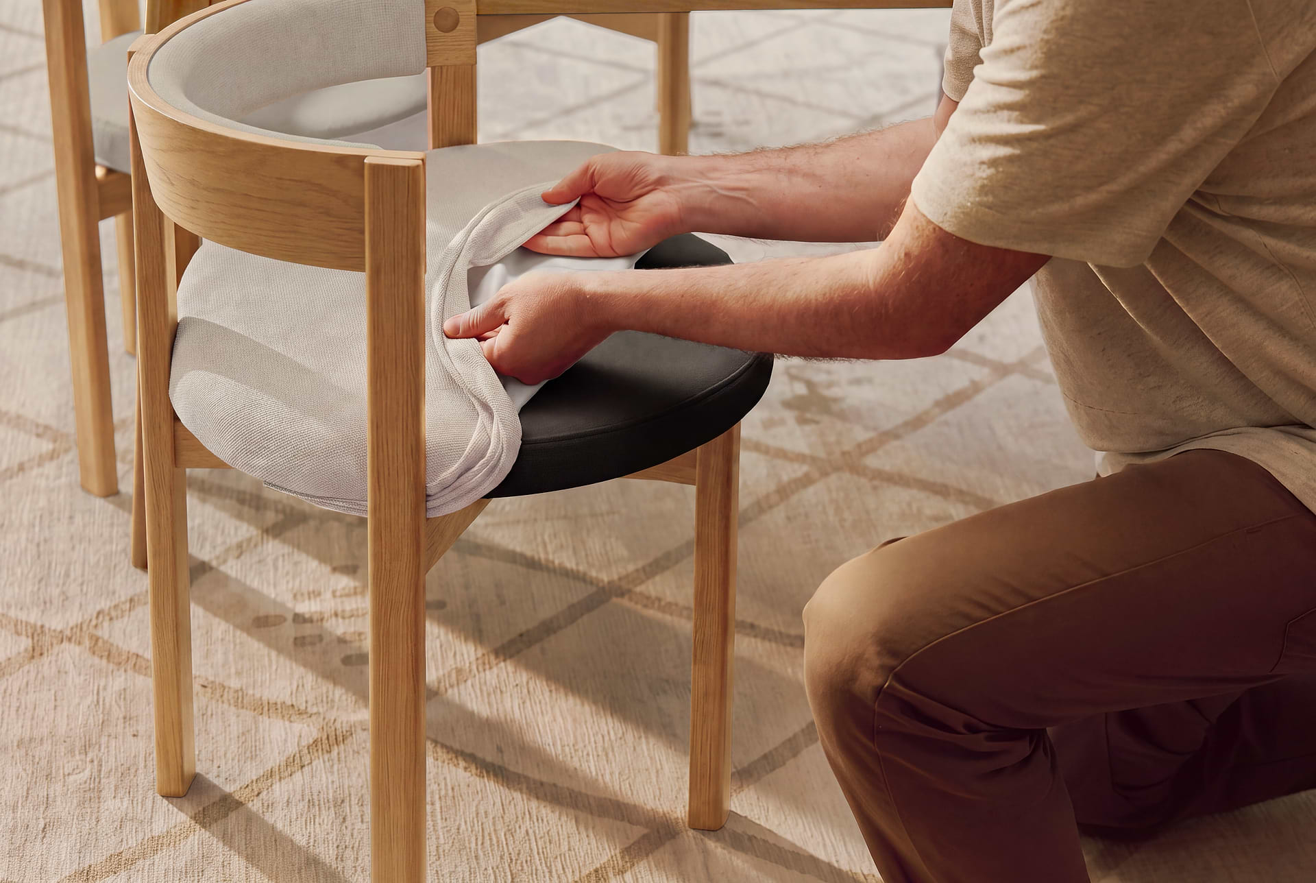 Men placing the yellow ushi chair cushion